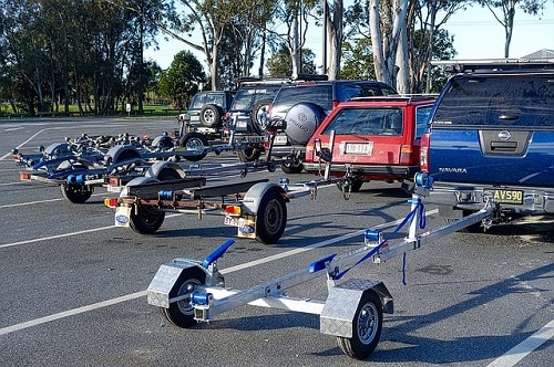 a number of cars with attached trailers on parking lot