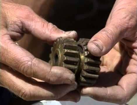 dirty hands holding parts of winch